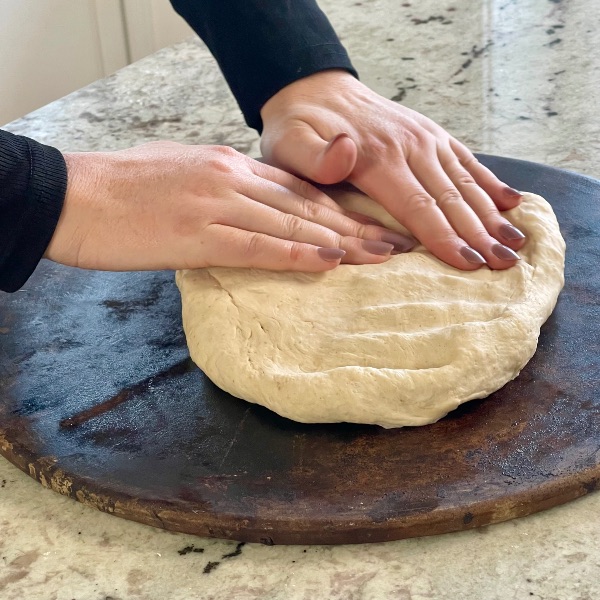 flattening pizza dough