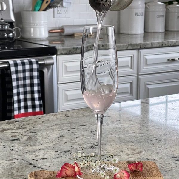 pouring a gin cocktail