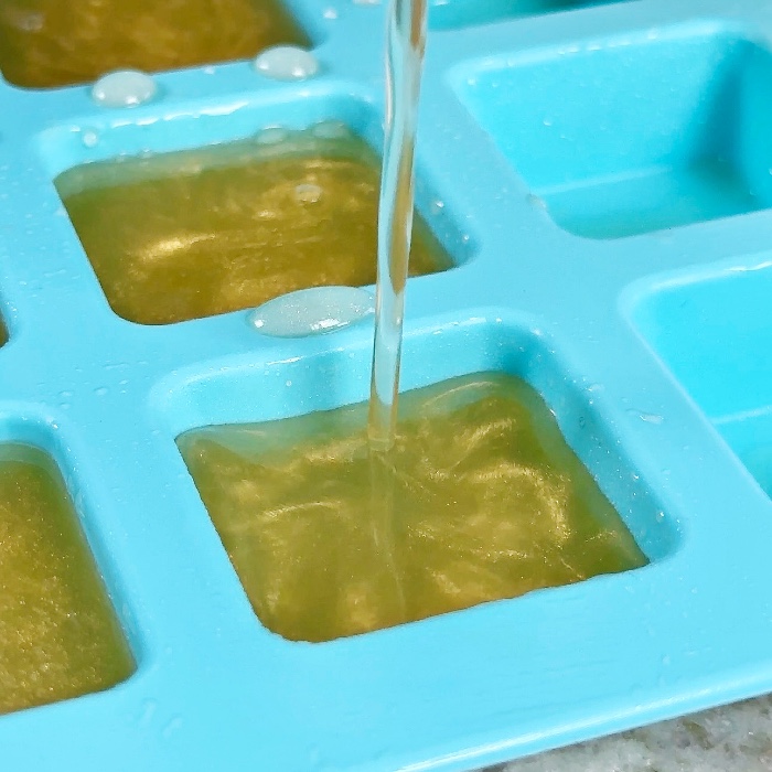 pouring jello shots into mold