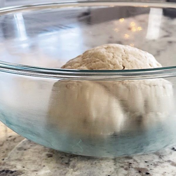 pizza dough ball in greased bowl.