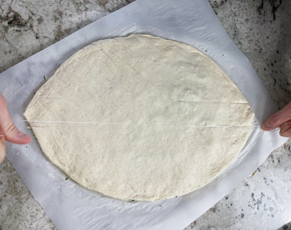 using floss to outline the cuts for football pizza