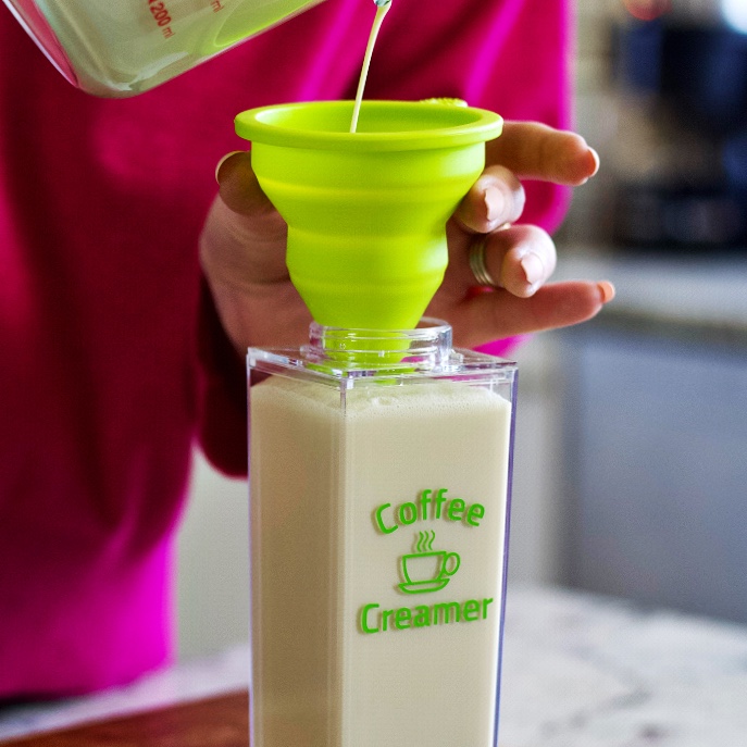 Homemade Coffee Creamer 6 pouring homemade coffee creamer into a container for storage using a funnel