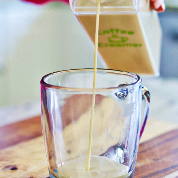 Homemade Coffee Creamer 3 pouring homemade coffee creamer into a coffee cup