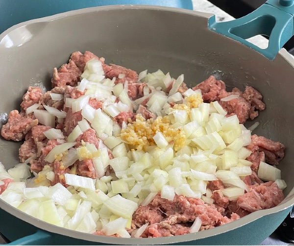 cooking ground turkey in skillet with onions and garlic