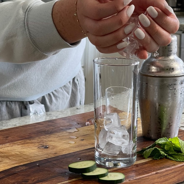 adding ice to glass