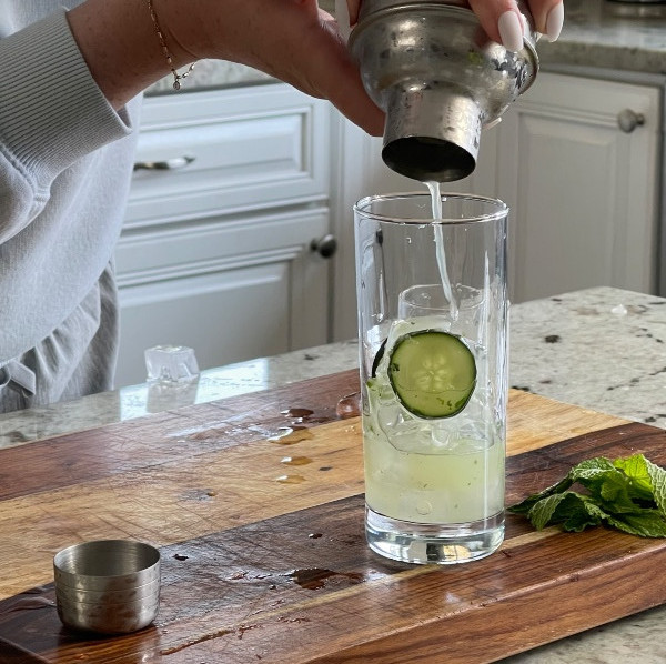 straining drink into glass