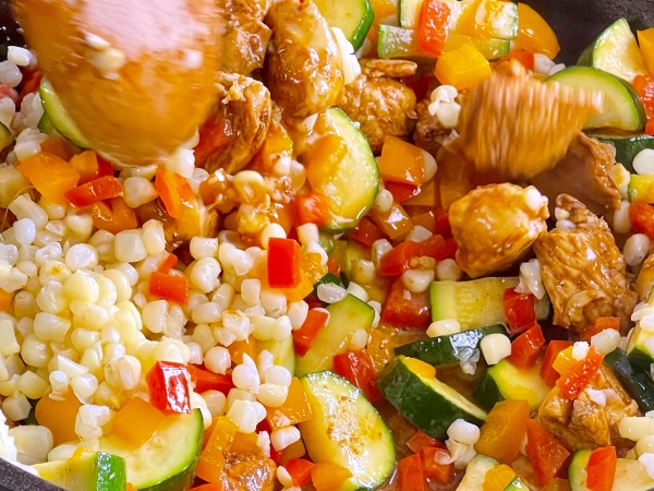 adding vegetable into the skillet