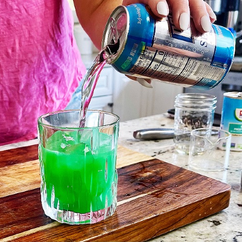 toping off blue hawaiian mocktail