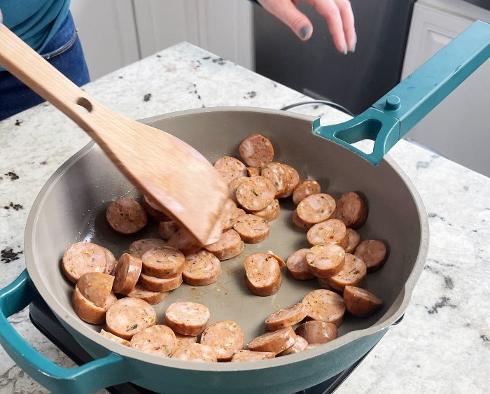 growing Italian sausage slices in a hot skillet