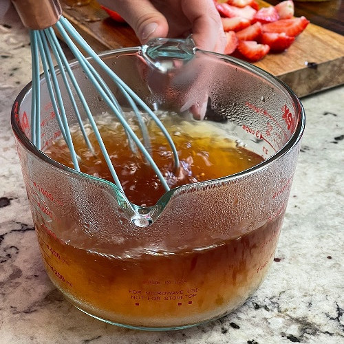 whisking sugar into tea