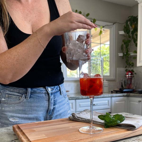 adding ice to strawberry bubbler mocktail