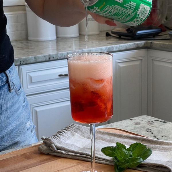 adding soda to strawberry bubbler mocktail