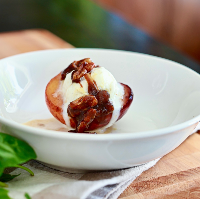 fried peach dessert with pecans and ice cream