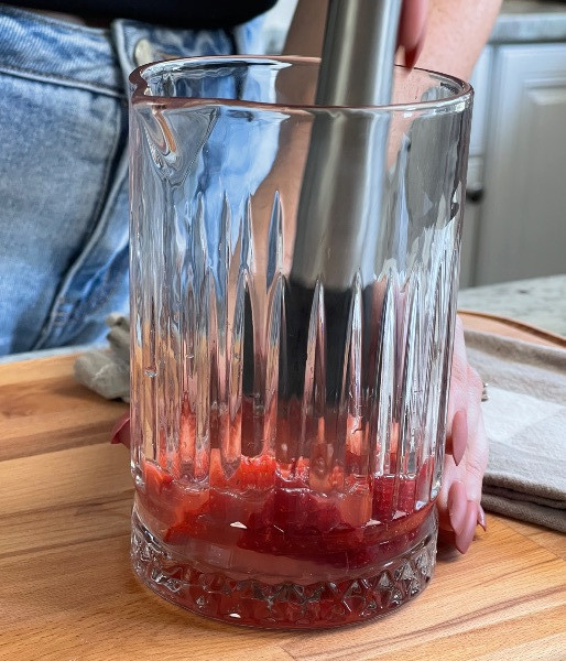 muddling ingredients for strawberry bubbler mocktail