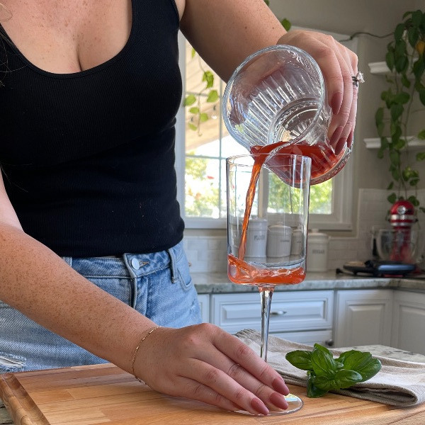 pouring muddled ingredients-strawberry bubbler mocktail