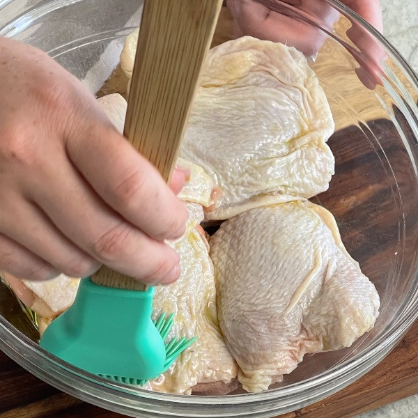 spread oil over chicken thighs