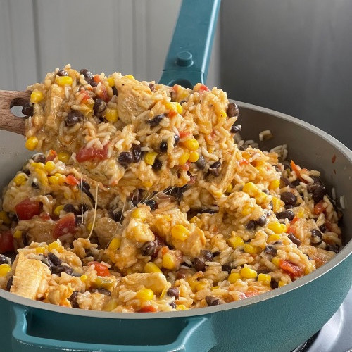 mexican chicken and rice in a blue skillet