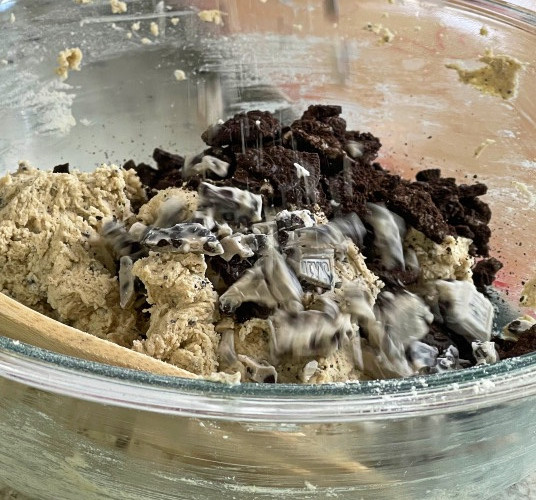 adding ingredients to cookie and creme cookie dough