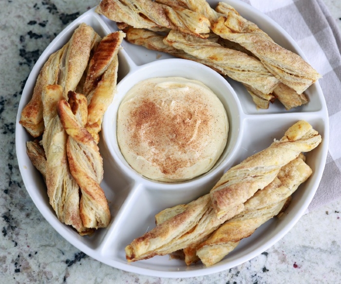 pumpkin pie twists with cream cheese dip in serving dish