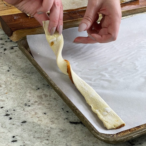 twisting pumkin pie twists on baking sheet