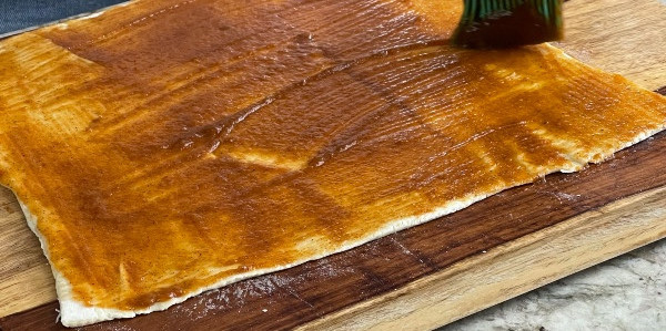 spreading pumpkin pie filling on phyllo dough