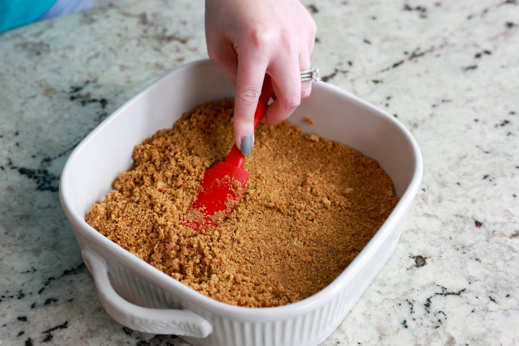 patting down no bake graham cracker crust