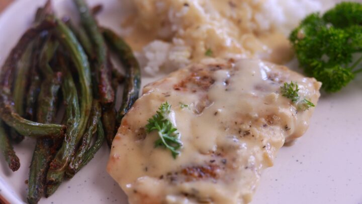 a plate of food with a side of green beans and rice