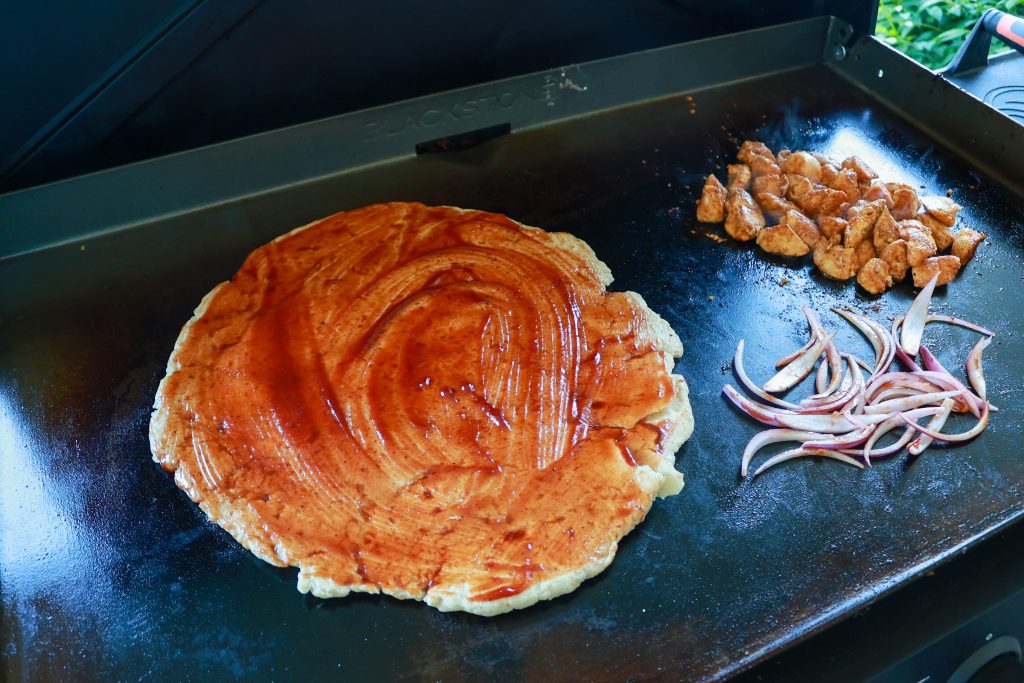Cooking barbecue chicken pizza on the blackstone