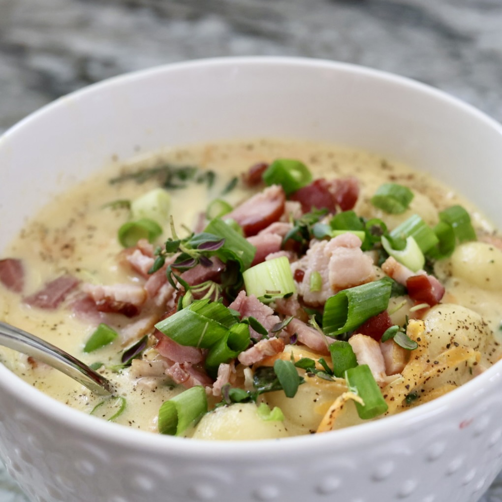 Creamy gnocchi soup with bacon and herbs