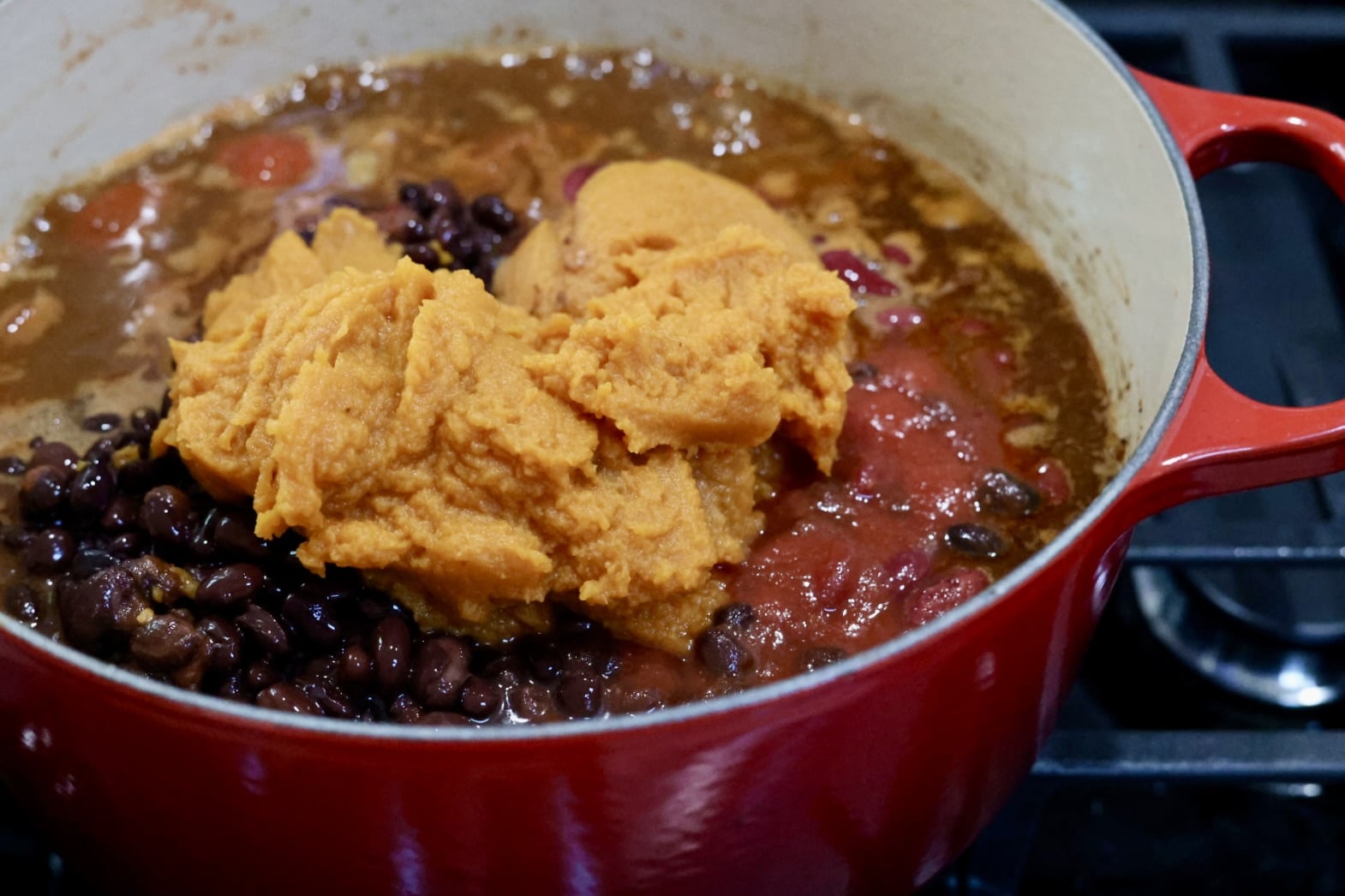 assembling Pot of chili with pumpkin puree