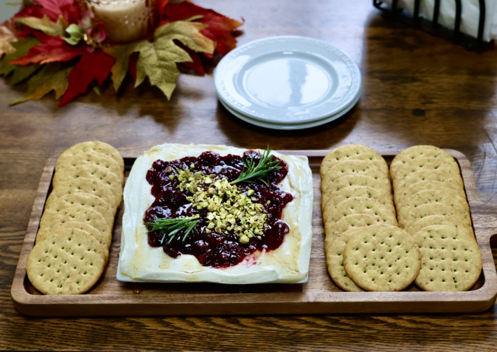 Cranberry Whipped Feta Dip topped with cranberry sauce, pistachios, and herbs