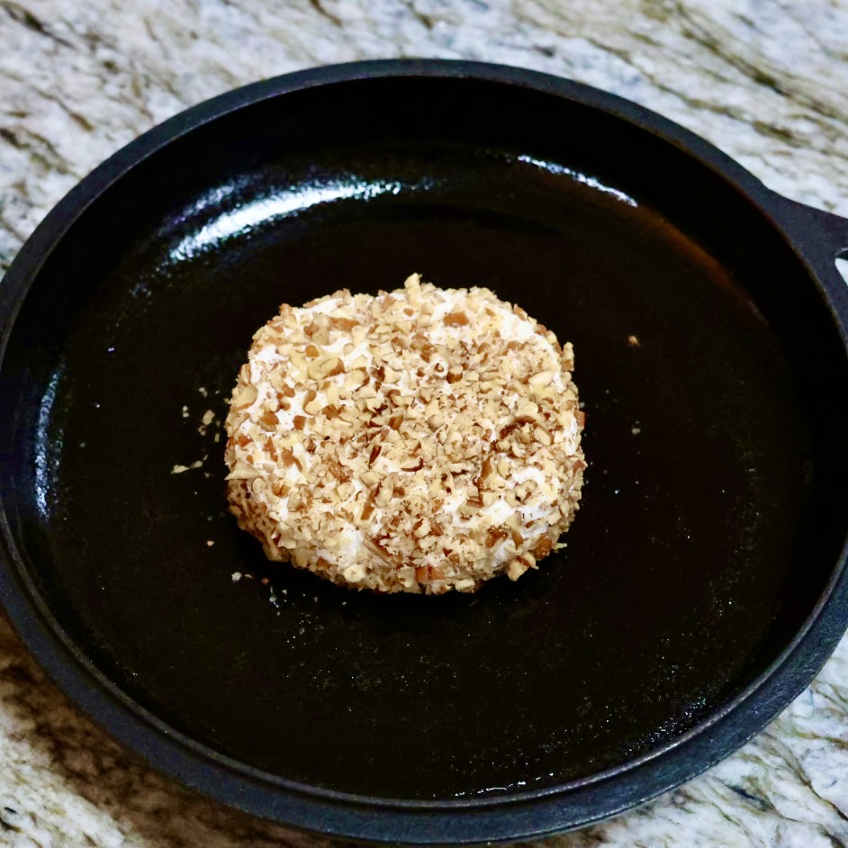 nut coated goat cheese in center of dish