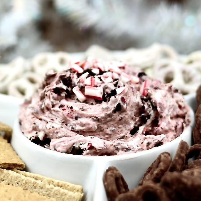 No-bake holiday appetizer dip with crushed candy canes and Oreos.Candy Cane Oreo Cheesecake Dip