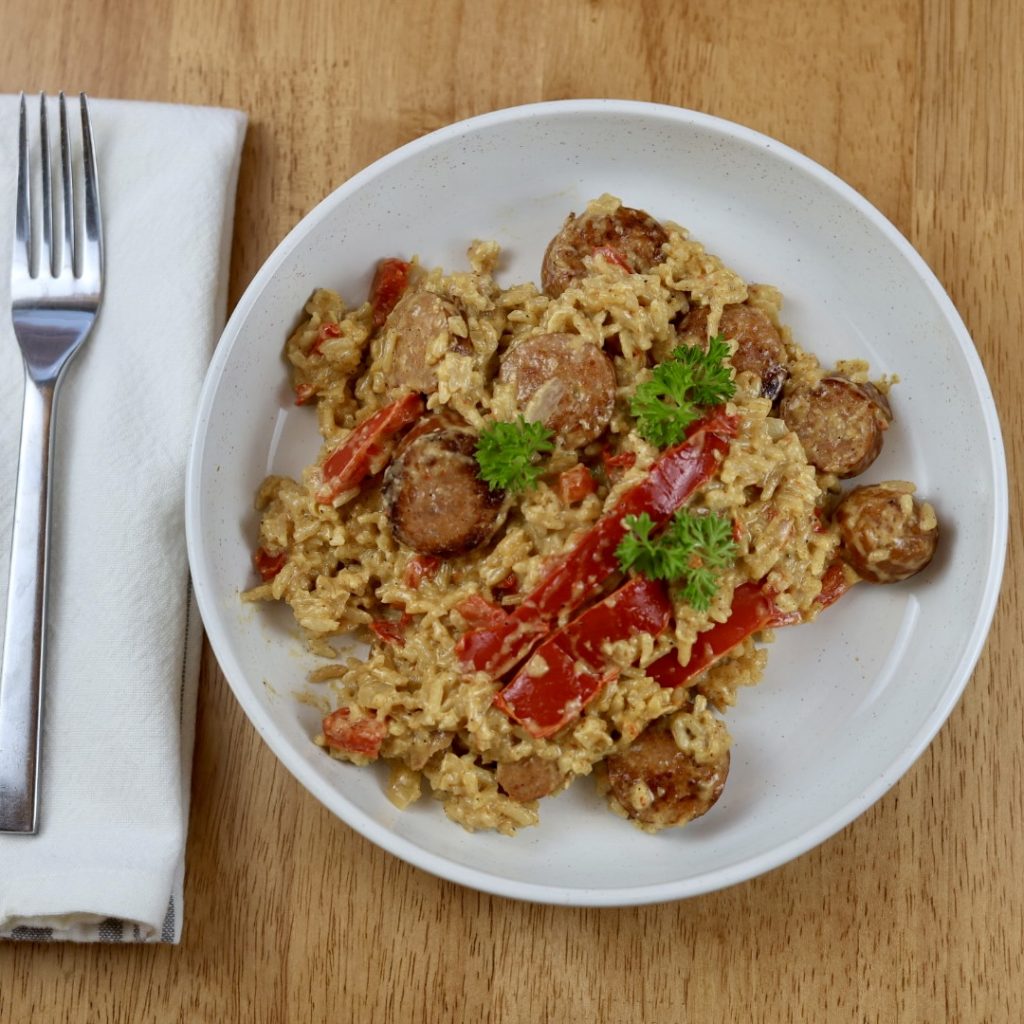 creamy cajun sausage and rice skillet dinner on a plate with fork