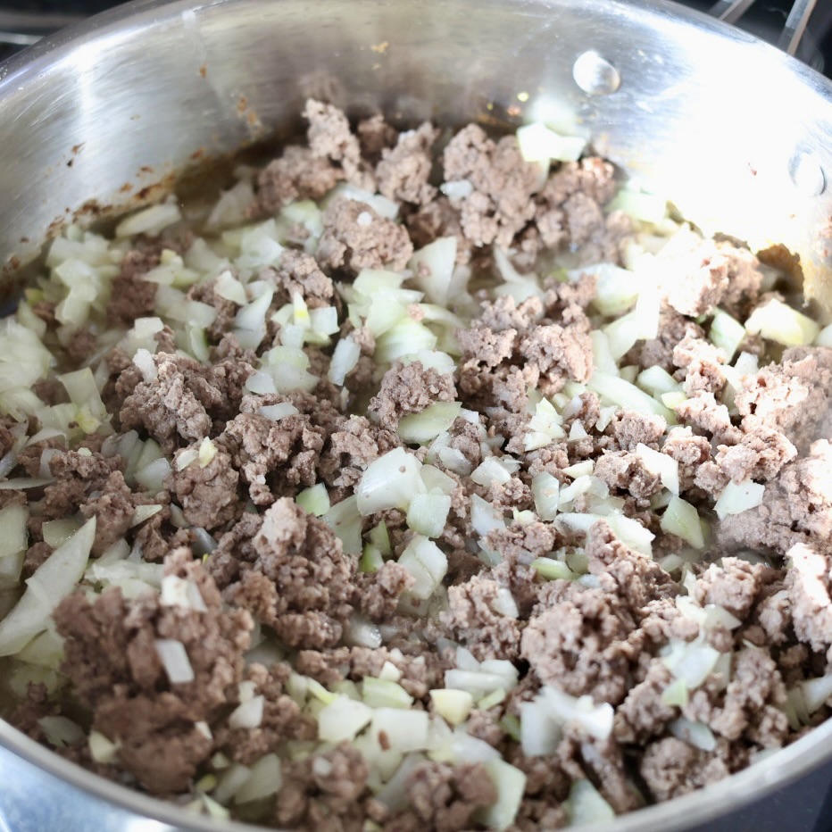 building creamy ground beef stroganoff with egg noodles in a skillet