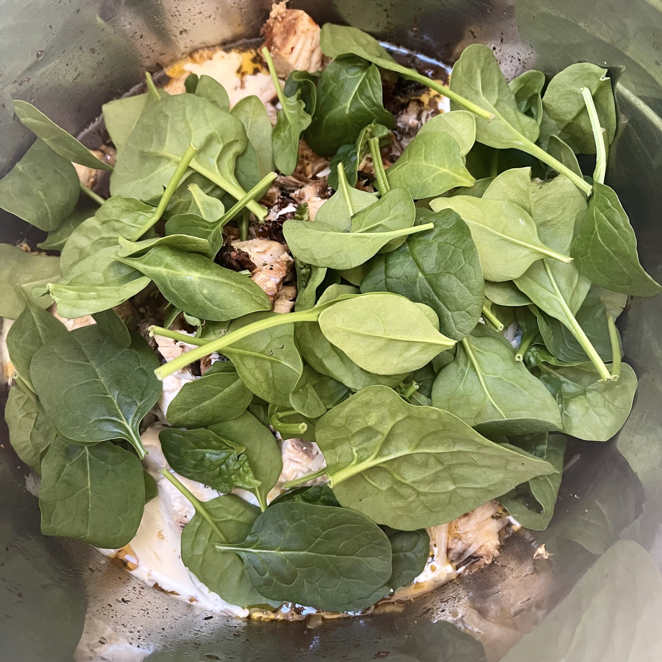 finishing crockpot Tuscan Chicken in the slow cooker