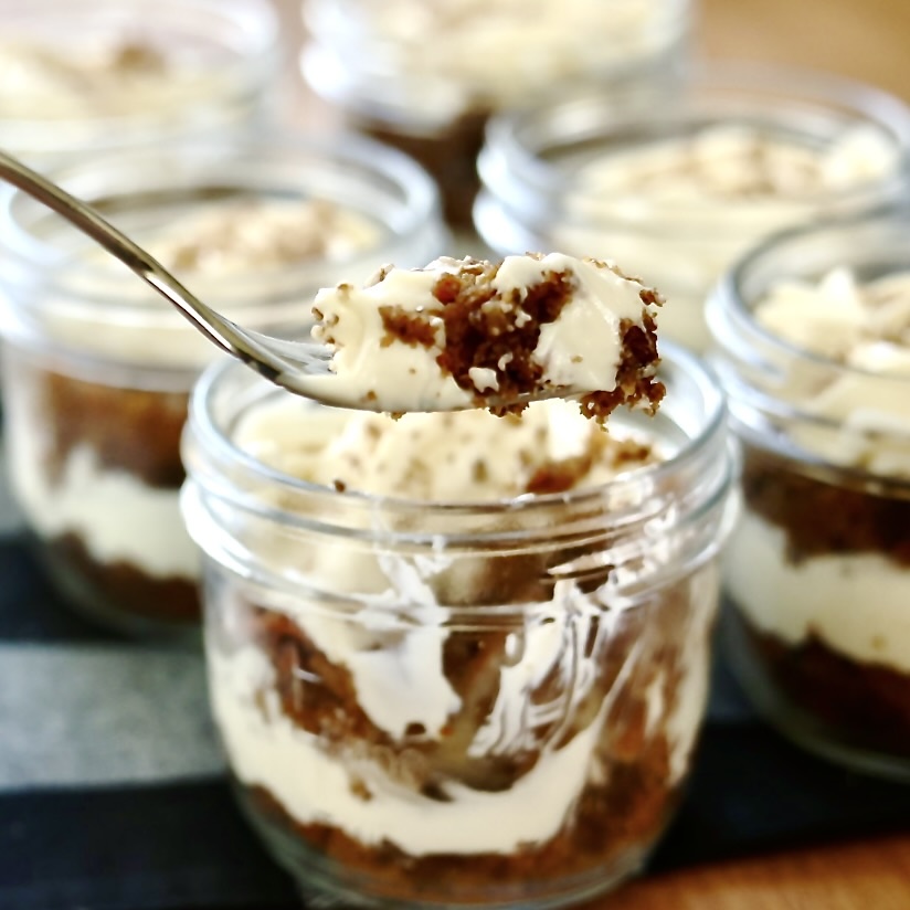 carrot cake trifle jars with a forkful out.