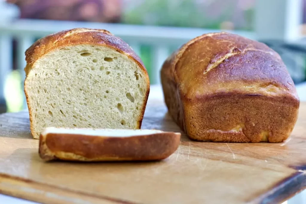Soft Sourdough Loaves one uncut the other sliced to show sandwich crumb