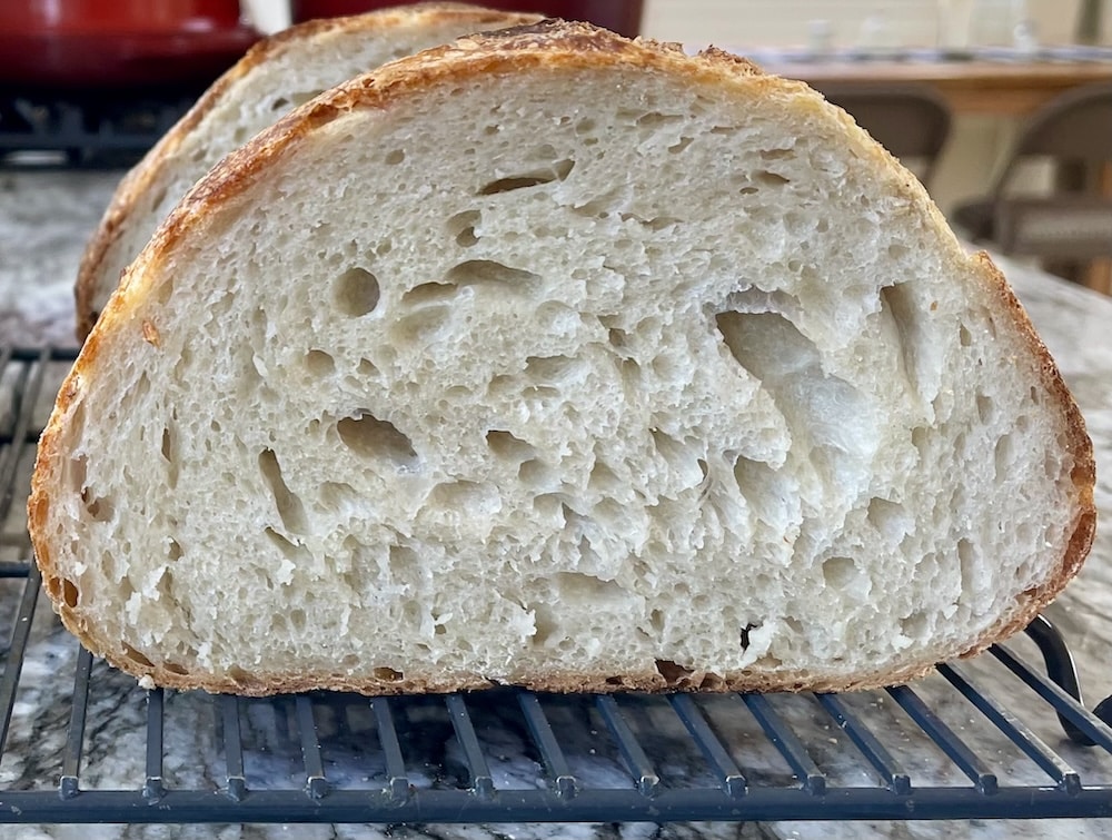 How to Control Sourdough Crumb (Open vs Soft Sandwich Style) 3 moderately open crumb sourdough loaf cut in half
