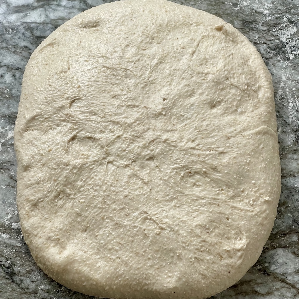 How to shape sourdough- lay the dough flat into a square-step 1
