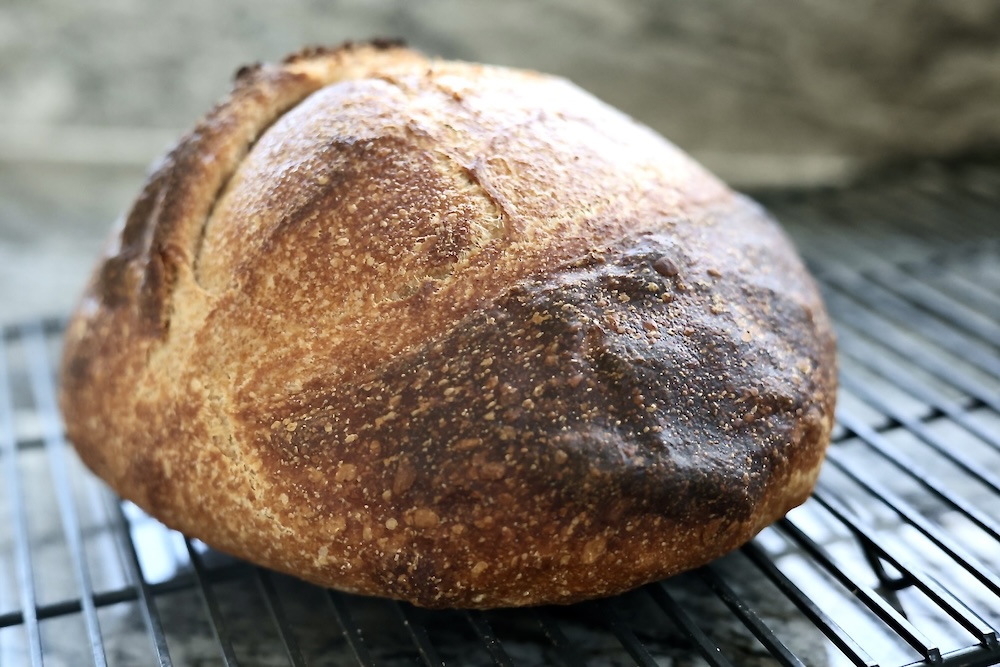 sourdough loaf with a dimpled crust