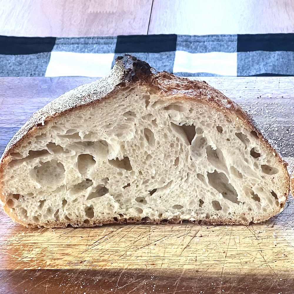 How to Control Sourdough Crumb (Open vs Soft Sandwich Style) 2 open sourdough crumb-loaf cut in half