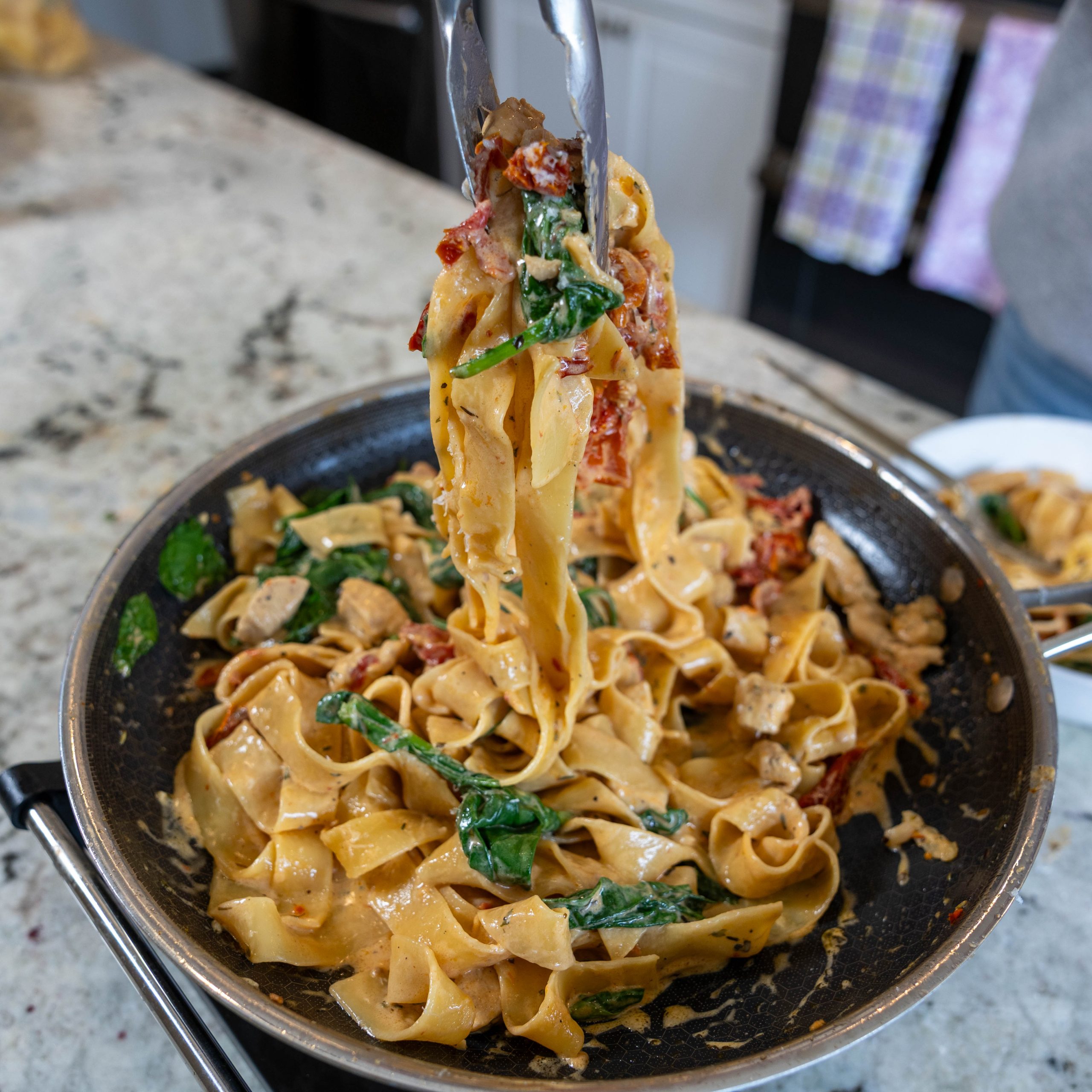 pull shot of creamy garlic chicken noodle dinner from skillet