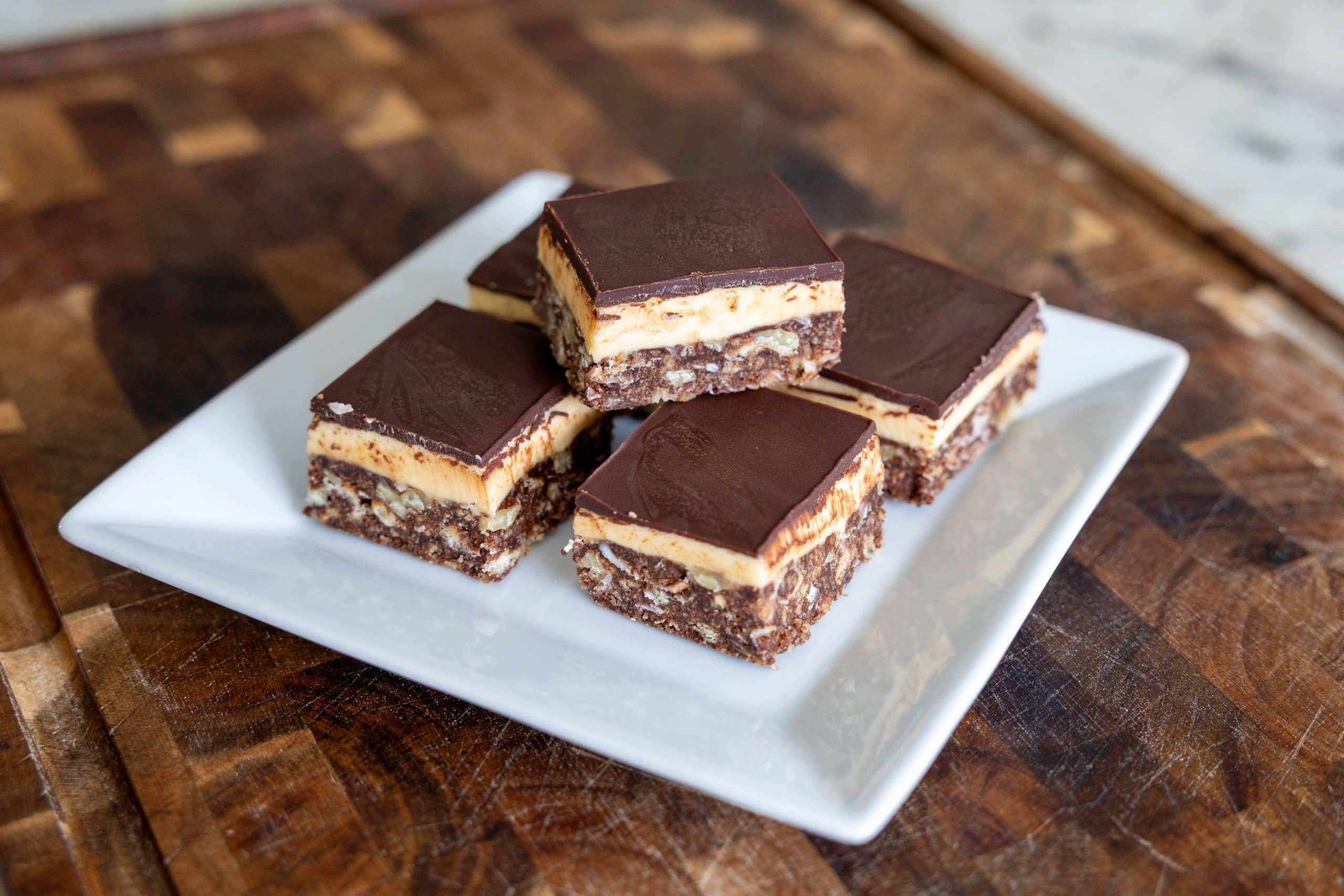 Nanaimo Bars on a plate with one stacked on top